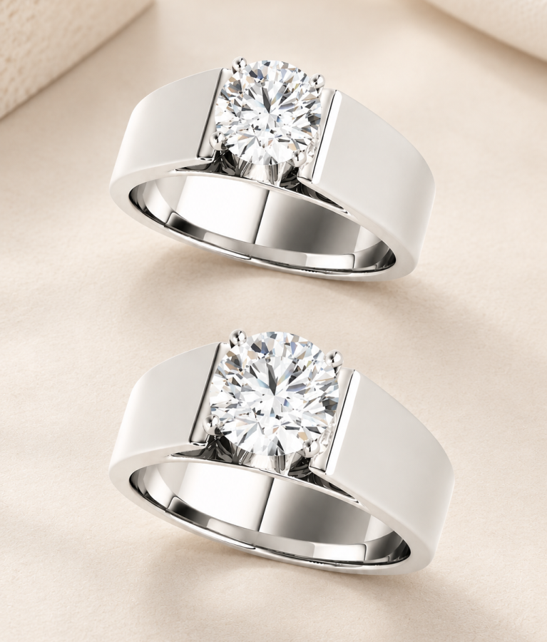 Bora engagement ring in white gold at 1 carat and 2 carats side by side, showing a larger round diamond on the same wide band