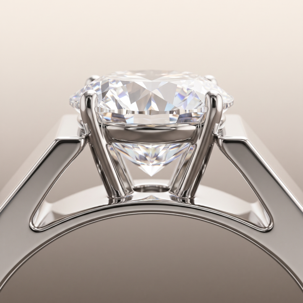 Bora engagement ring close-up: a round lab-grown diamond set in a notch in a wide, flat white gold band