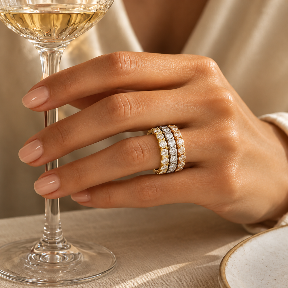 Three Layla diamond eternity bands stacked on one finger in white, yellow and rose gold