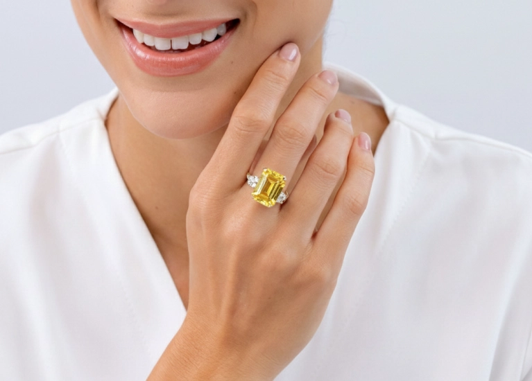 Emerald-cut sapphire ring worn on hand, highlighting modern elegance and clean geometry