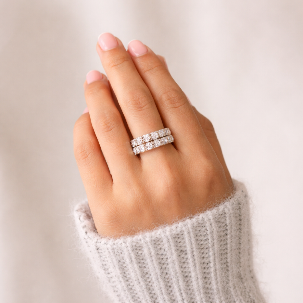 Stacked diamond eternity bands worn on hand representing milestone jewelry
