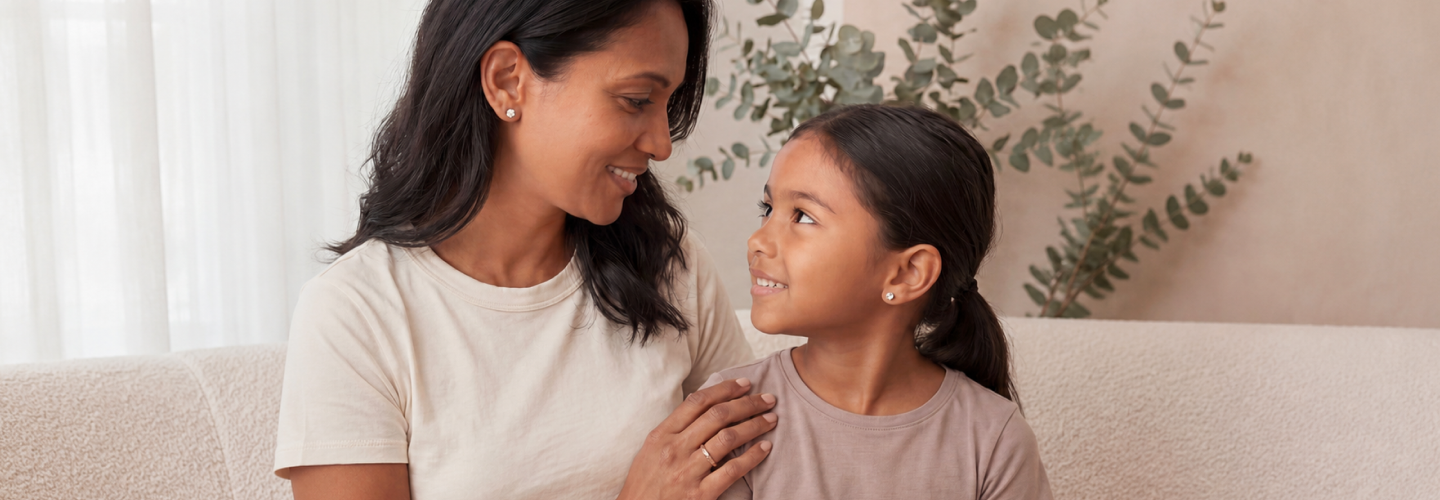 Mother and daughter sharing a moment wearing fine jewelry in soft natural light
