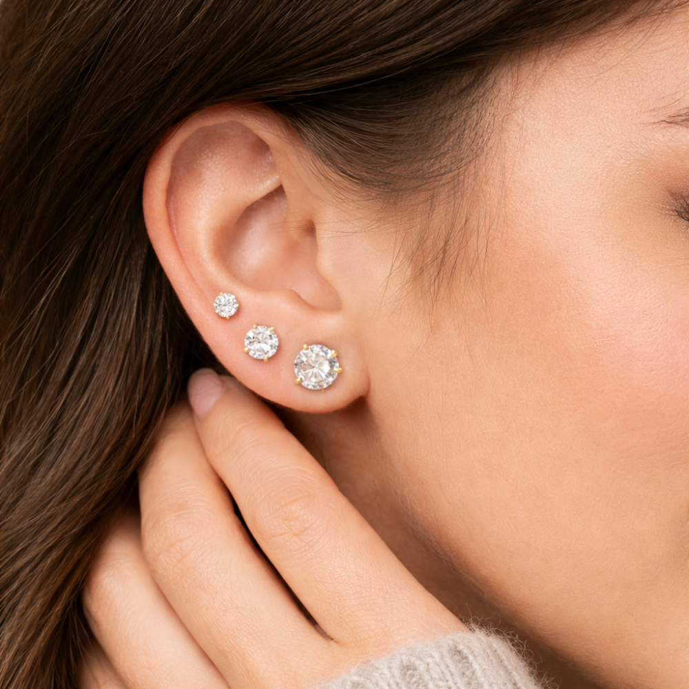Diamond stud earrings worn on ear as everyday fine jewelry