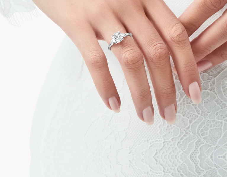 close-up-of-engagement-ring-in-hand-or-soft-bokeh