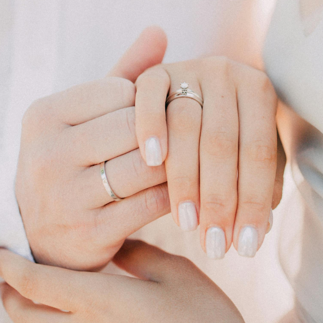 Couple holding hands with ethical diamond engagement ring by SAMA