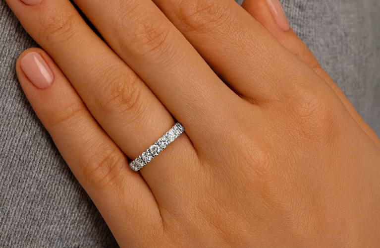 Close-up of a diamond eternity wedding band worn on hand — symbol of everlasting love, crafted in 18K white gold by SAMA