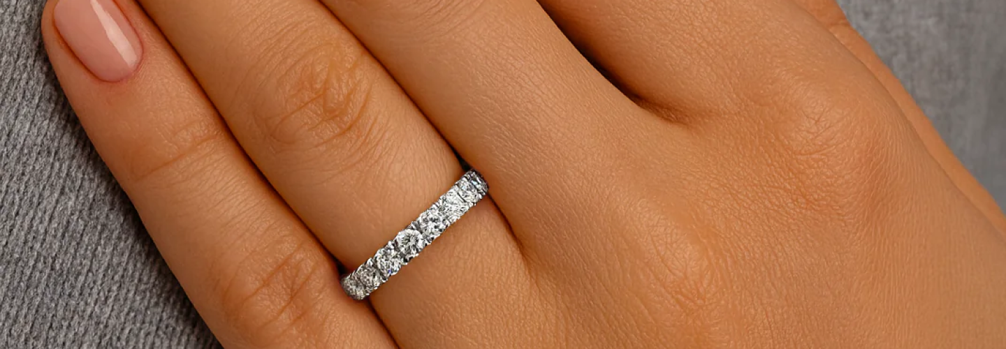 Close-up of a diamond eternity wedding band worn on hand — symbol of everlasting love, crafted in 18K white gold by SAMA