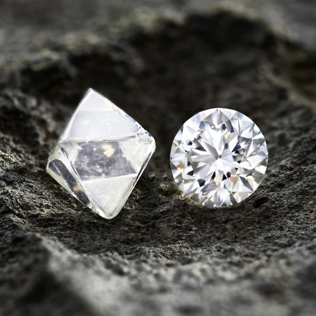 Natural and lab-grown diamonds side by side on black stone background