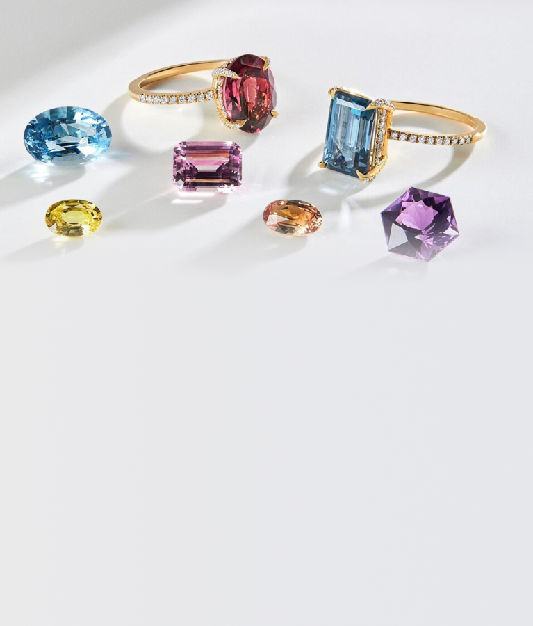 Loose gemstones and engagement rings displayed together by SAMA