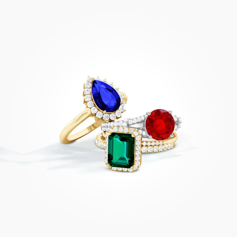 Sapphire, emerald, and ruby gemstone rings in 18k gold