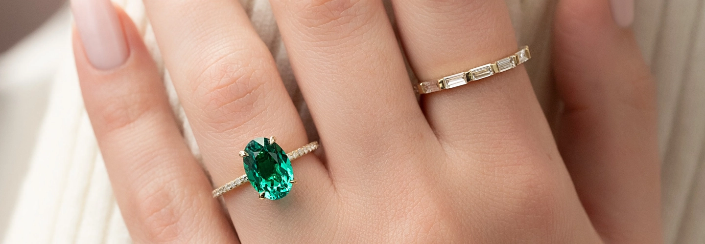 Emerald oval solitaire engagement ring styled for holiday gifting