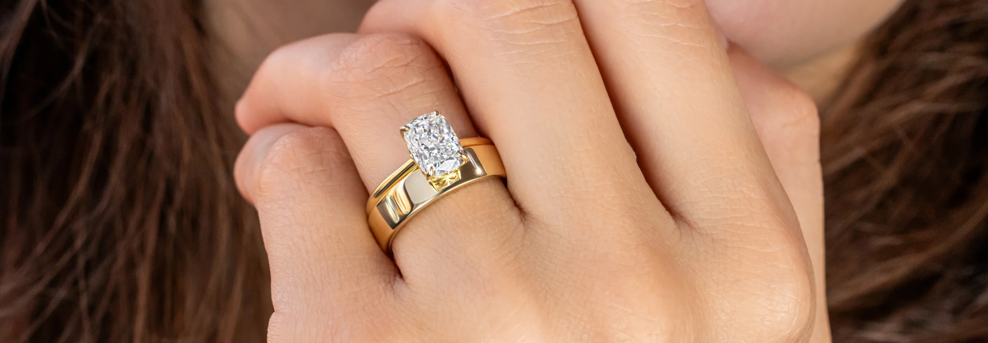 Oval engagement ring comparison featuring a yellow-gold plain band like Vanessa Hudgens and a white-gold pavé band like Simone Biles.