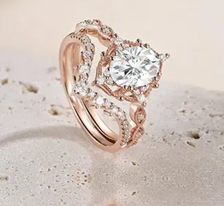Intricate vintage-style engagement ring in rose gold with round center diamond by SAMA