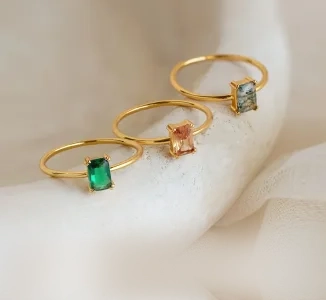 Gold rings with emerald, sapphire, and ruby gemstones by SAMA